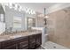 Bright bathroom features granite counters, double vanity, and tiled glass shower at 3478 74Th Avenue E Cir, Sarasota, FL 34243