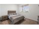 Bedroom featuring a large window, bedside table, and neutral decor at 3478 74Th Avenue E Cir, Sarasota, FL 34243