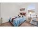 Bedroom featuring a large window, bedside table, and neutral decor at 3478 74Th Avenue E Cir, Sarasota, FL 34243