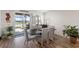 Dining room with sliding glass doors leading to a screened lanai and views of the pool and lake at 3478 74Th Avenue E Cir, Sarasota, FL 34243
