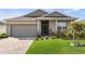 Charming home featuring a well-manicured lawn, beautiful landscaping, and a welcoming front entrance at 3478 74Th Avenue E Cir, Sarasota, FL 34243