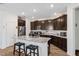 Well-equipped kitchen boasting dark wood cabinetry, granite countertops, and an island with barstools at 3478 74Th Avenue E Cir, Sarasota, FL 34243