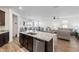 Spacious open-concept kitchen features granite counters and island with stainless steel appliances and adjacent living areas at 3478 74Th Avenue E Cir, Sarasota, FL 34243