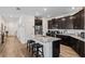 Modern kitchen with granite counters, stainless steel appliances, and an island with bar stool seating at 3478 74Th Avenue E Cir, Sarasota, FL 34243