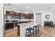 Modern kitchen featuring dark cabinets, granite counters, and a large center island with seating at 3478 74Th Avenue E Cir, Sarasota, FL 34243