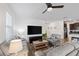 Comfortable living room with neutral furnishings and a modern ceiling fan at 3478 74Th Avenue E Cir, Sarasota, FL 34243