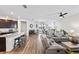Open-concept living space with island kitchen, dining area and a comfortable living room at 3478 74Th Avenue E Cir, Sarasota, FL 34243