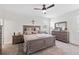 Serene primary bedroom with a large bed, dresser, and soft natural light at 3478 74Th Avenue E Cir, Sarasota, FL 34243