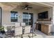 Outdoor patio area features a dining set, views of the pool, and outdoor entertaining space at 3478 74Th Avenue E Cir, Sarasota, FL 34243