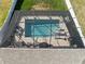 Aerial view of a screened-in pool with lounge chairs and outdoor seating, perfect for relaxation and entertainment at 3478 74Th Avenue E Cir, Sarasota, FL 34243