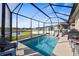Stunning screened-in pool with comfortable lounge chairs and peaceful water views at 3478 74Th Avenue E Cir, Sarasota, FL 34243