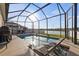 Enclosed pool area with lounge chairs offering relaxation and scenic lake views at 3478 74Th Avenue E Cir, Sarasota, FL 34243