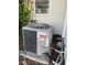 Air conditioning unit is located on the side of the house under a window with a plant nearby at 3705 Chinaberry Rd, Bradenton, FL 34208