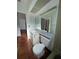 Modest bathroom includes toilet and vanity with marble countertop and a large frameless mirror at 3705 Chinaberry Rd, Bradenton, FL 34208