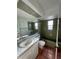 Charming bathroom featuring a window, shower/bath combo, marble countertops, and earth-tone tile flooring at 3705 Chinaberry Rd, Bradenton, FL 34208