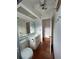 Simple bathroom featuring a toilet, vanity with sink, large mirror, and red tiled floor at 3705 Chinaberry Rd, Bradenton, FL 34208