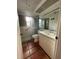 Bathroom includes a sink, toilet, shower with green tiling and tile flooring at 3705 Chinaberry Rd, Bradenton, FL 34208