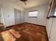 Bedroom features tile flooring, a window with blinds, and a closet with sliding doors at 3705 Chinaberry Rd, Bradenton, FL 34208