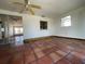Bright sunroom with sliding glass doors, connecting rooms, a ceiling fan, and red tile flooring at 3705 Chinaberry Rd, Bradenton, FL 34208
