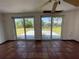 Bright living area featuring tile flooring, sliding glass doors to the outdoors, and a ceiling fan at 3705 Chinaberry Rd, Bradenton, FL 34208