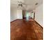 Open-concept living room with terracotta tile flooring, ceiling fans, and ample natural light at 3705 Chinaberry Rd, Bradenton, FL 34208