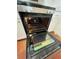 Stainless steel oven with glass door and white cabinets; terra cotta tile flooring at 3705 Chinaberry Rd, Bradenton, FL 34208