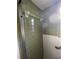 The shower is tiled with green tiles on top and white tiles on the bottom, with a chrome towel bar at 3705 Chinaberry Rd, Bradenton, FL 34208