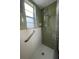 Shower with green and white tiling, a shower head, and a window at 3705 Chinaberry Rd, Bradenton, FL 34208