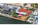 Aerial view of a waterfront property featuring a pool, boat dock, and ample outdoor living space on a canal at 3716 Coconut Ter, Bradenton, FL 34210
