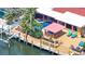 Aerial view of waterfront backyard featuring a private pool, spa, outdoor bar, and dock with boat access at 3716 Coconut Ter, Bradenton, FL 34210