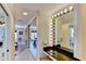 Vanity area with light up mirror, marble counter, and a view into the Primary bedroom at 3716 Coconut Ter, Bradenton, FL 34210