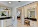 Bright bathroom with vanity, makeup station, and glimpse into adjacent bedroom at 3716 Coconut Ter, Bradenton, FL 34210