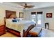 Relaxing bedroom with hardwood floors, ceiling fan, and a door that opens up to the backyard at 3716 Coconut Ter, Bradenton, FL 34210