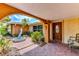 Inviting front entrance with a decorative fountain, colorful landscaping, and a charming arched entryway at 3716 Coconut Ter, Bradenton, FL 34210