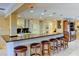 Kitchen bar that faces the kitchen, with modern light fixtures and white cabinets at 3716 Coconut Ter, Bradenton, FL 34210