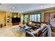 Modern living room with a large leather sofa, area rug, and custom built-in shelving at 3716 Coconut Ter, Bradenton, FL 34210