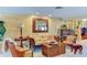 A cozy living room featuring elegant furniture, a decorative fireplace, and ample natural light at 3716 Coconut Ter, Bradenton, FL 34210