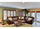 Comfortable living room with a large sofa, natural light, and an open layout with access to the patio at 3716 Coconut Ter, Bradenton, FL 34210