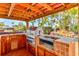 Gourmet outdoor kitchen with stainless steel grill and tiled countertops, great for outdoor entertaining at 3716 Coconut Ter, Bradenton, FL 34210