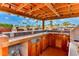 Well-equipped outdoor kitchen with tile countertops and ample storage, ideal for hosting waterfront barbecues at 3716 Coconut Ter, Bradenton, FL 34210