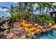 Tropical pool featuring a rock waterfall and lush landscaping provides a relaxing outdoor retreat at 3716 Coconut Ter, Bradenton, FL 34210