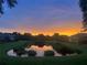 Beautiful backyard pond view during golden hour, offering a serene landscape and peaceful setting at 406 Petrel Trl, Bradenton, FL 34212