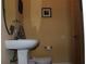 Bathroom featuring pedestal sink with chrome fixtures, toilet and wall art at 406 Petrel Trl, Bradenton, FL 34212