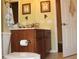 Bathroom featuring a dark wood vanity with double sinks and a decorative mirror, enhancing the bathroom's charm at 406 Petrel Trl, Bradenton, FL 34212