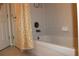 Bathroom bathtub with a shower, set against a bright and clean tile surround, enhancing the room's appeal at 406 Petrel Trl, Bradenton, FL 34212
