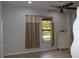 Bedroom with tile floors, a ceiling fan, and neutral walls at 406 Petrel Trl, Bradenton, FL 34212