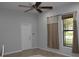 Bedroom with a ceiling fan, window, and tile floors at 406 Petrel Trl, Bradenton, FL 34212