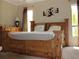 Comfortable bedroom with a wooden bed frame and natural light at 406 Petrel Trl, Bradenton, FL 34212