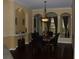 Elegant dining room with a marble table, black leather chairs, and a decorative chandelier at 406 Petrel Trl, Bradenton, FL 34212