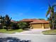 Attractive single-story home with well-maintained lawn, mature palm trees and a brick-paved driveway at 406 Petrel Trl, Bradenton, FL 34212